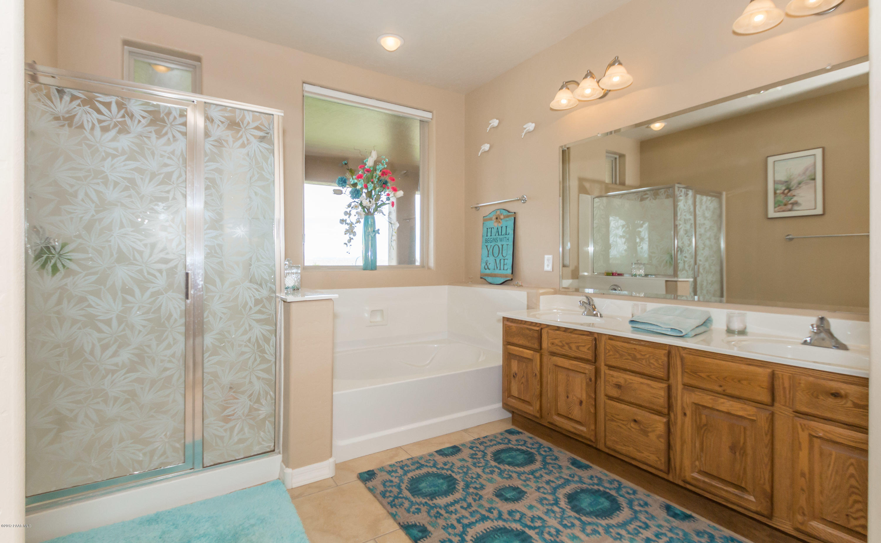 1197 Rusty Nail Road Prescott Valley, AZ 86314 - Photo 10 of 40 a bathroom with a double vanity sink mirror and shower