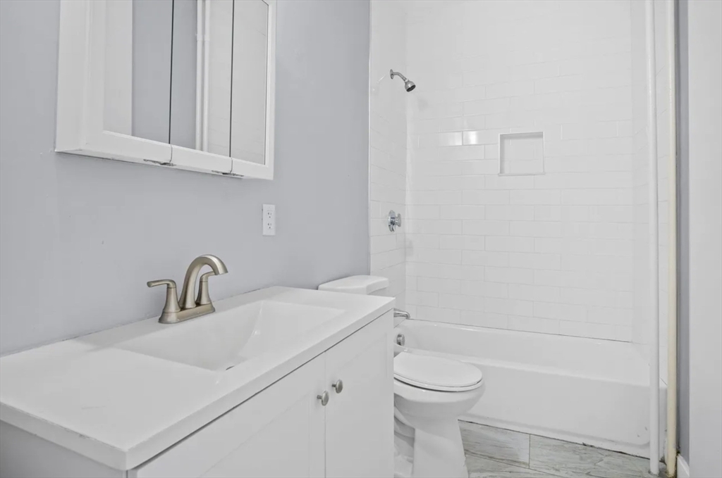 52 Intervale Street Boston, MA 02121 - Photo 7 of 16 a bathroom with a sink a toilet and shower