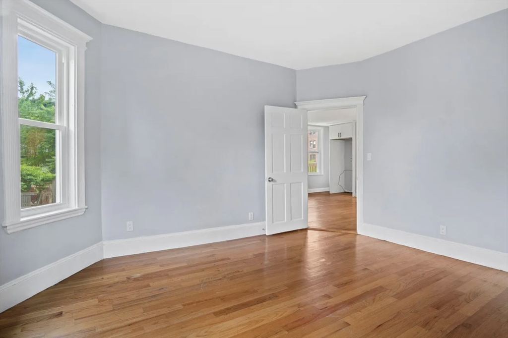52 Intervale Street Boston, MA 02121 - Photo 9 of 16 a view of empty room with wooden floor and fan