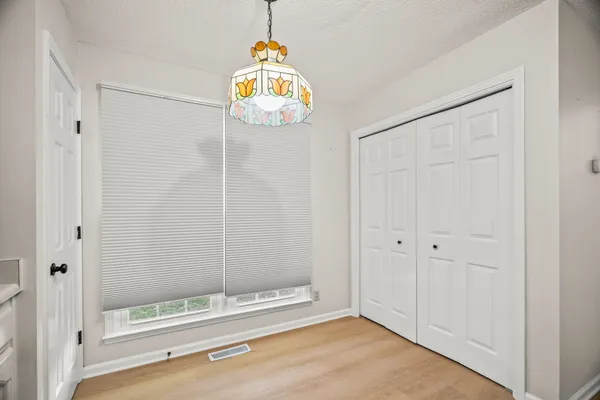 a bathroom with a shower and a view of hallway