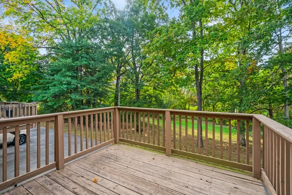 a balcony with wooden floor and fence