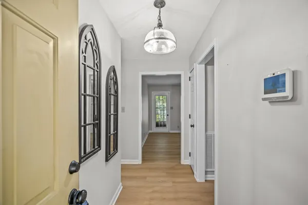 a view of a hallway with wooden floor