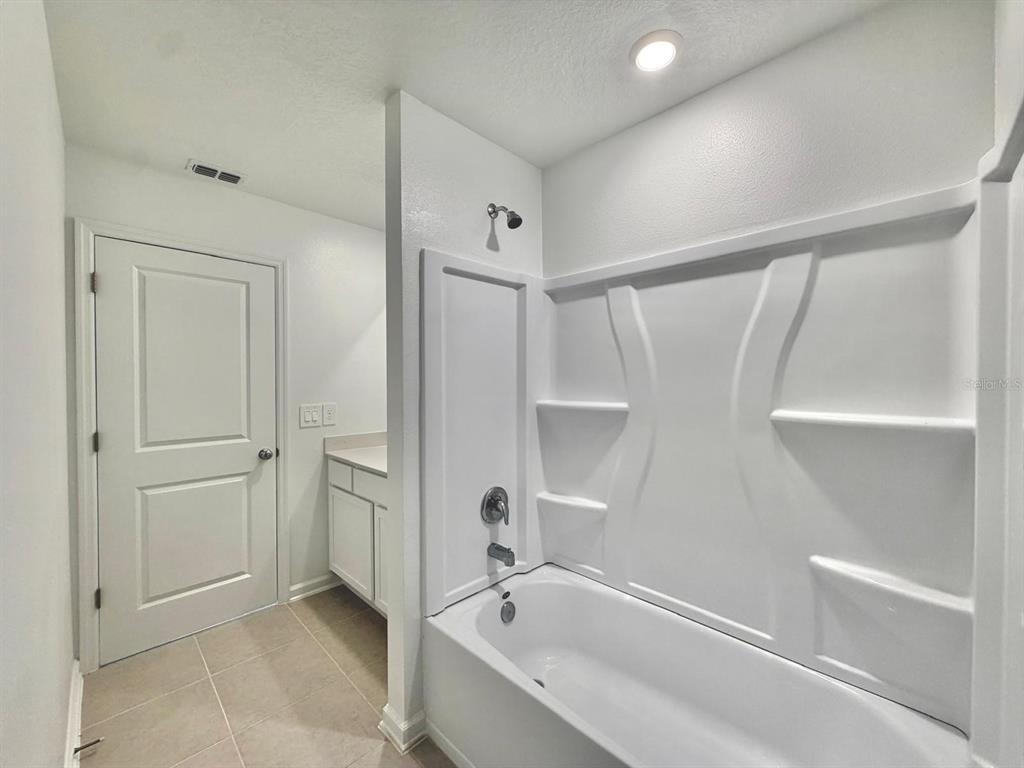 2764 Lookout Rdg Road Haines City, FL 33844 - Photo 18 of 21 a bathroom with a bathtub and a shower