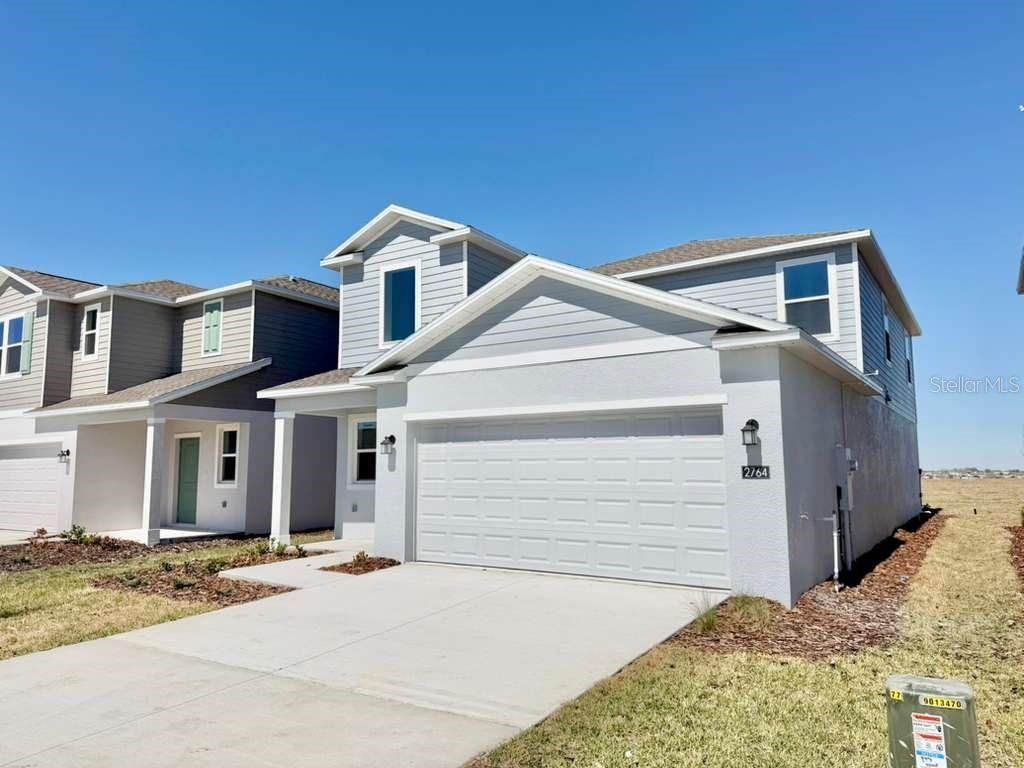 2764 Lookout Rdg Road Haines City, FL 33844 - Photo 2 of 21 a front view of a house with a yard