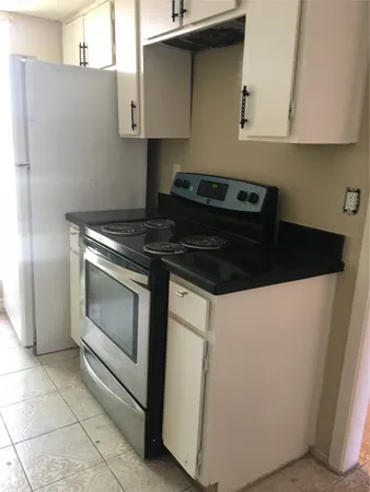 a kitchen with a stove and a cabinet