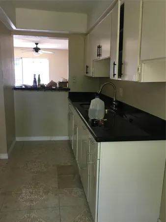 a kitchen with a sink and cabinets