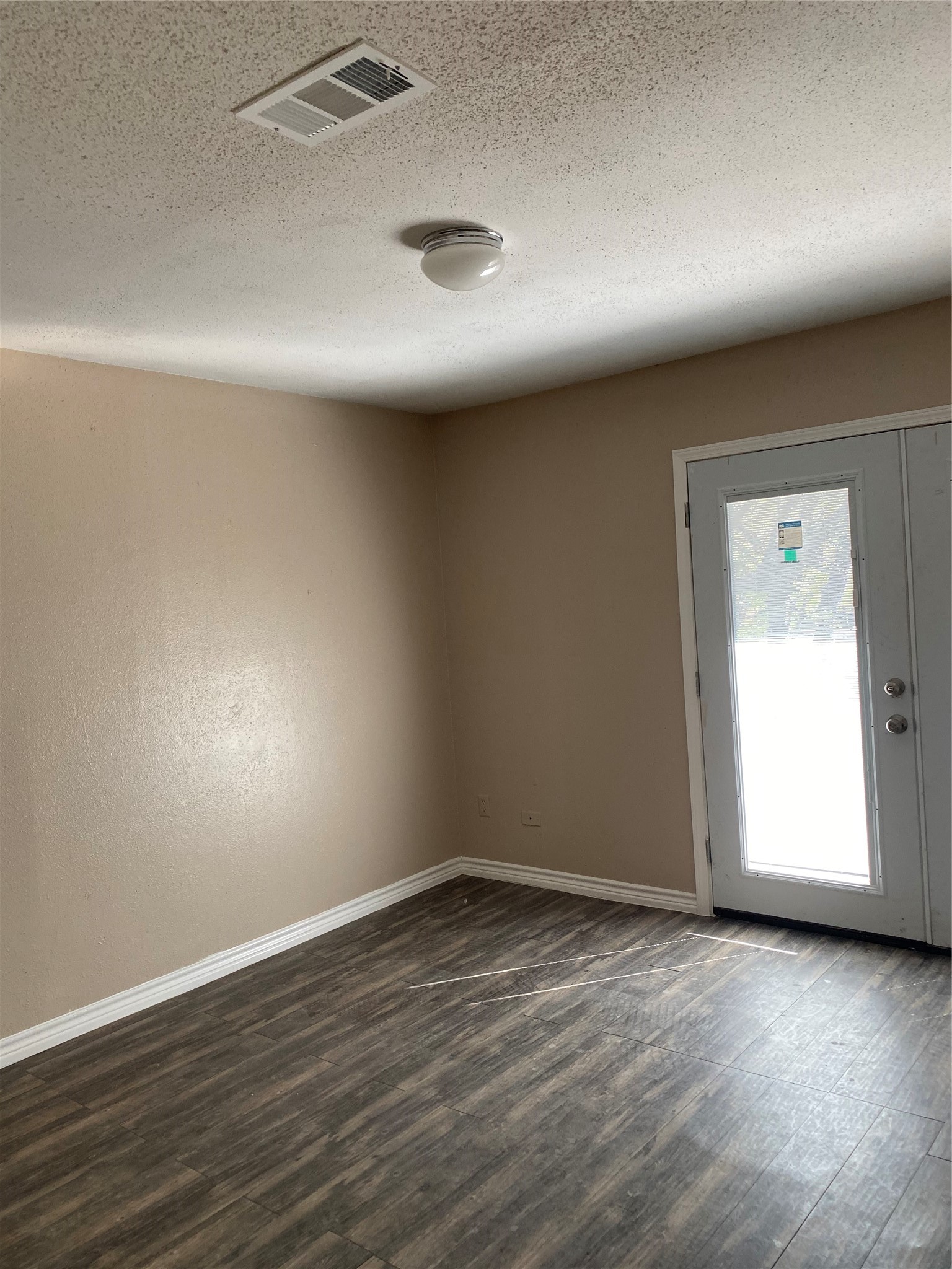 7952 Grove Ridge Drive Houston, TX 77061 - Photo 8 of 12 an empty room with wooden floor and windows