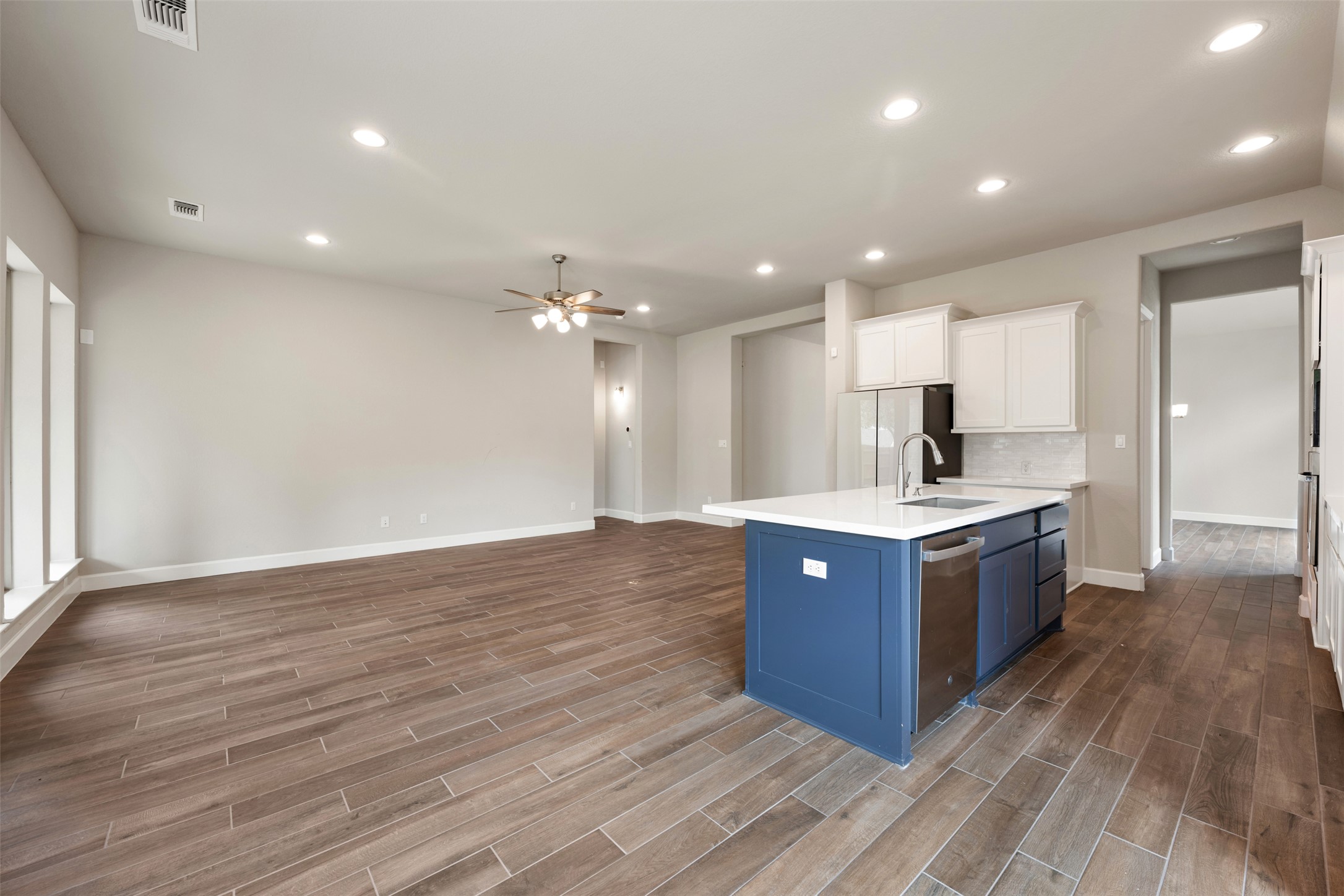 104 Anejo Bluff Georgetown, TX 78628 - Photo 7 of 40 a kitchen with kitchen island granite countertop wooden cabinets and white stainless steel appliances