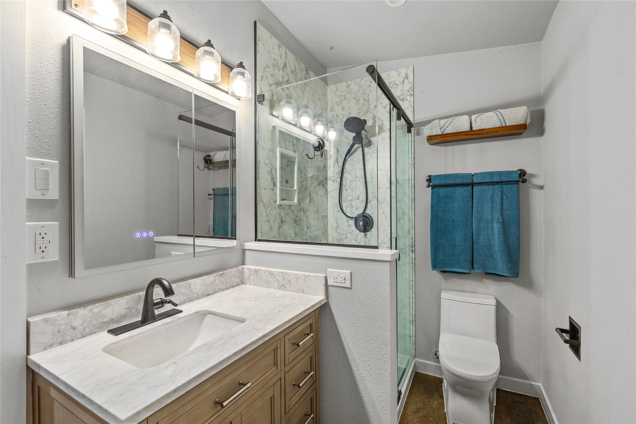 8200 Ranch Road 12 San Marcos, TX 78666 - Photo 20 of 40 A well-appointed bathroom features a modern vanity with elegant countertops and a sleek glass-enclosed shower.