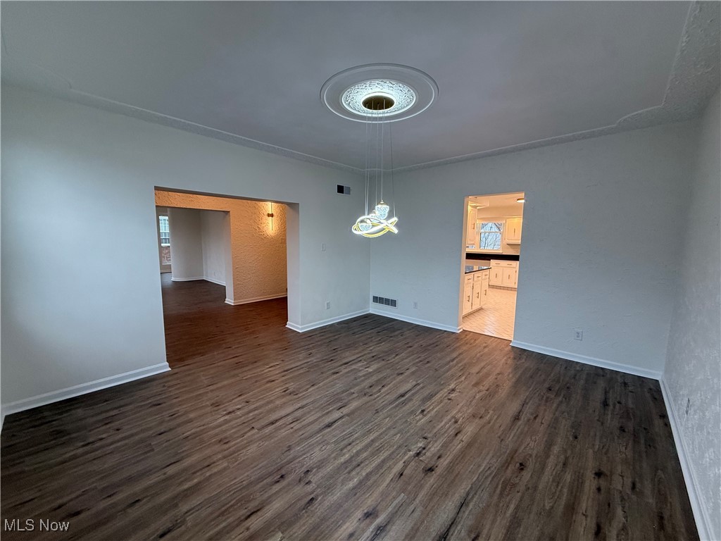 522 North 3rd Street Toronto, OH 43964 - Photo 8 of 47 Unfurnished dining area with dark wood finished floors and baseboards