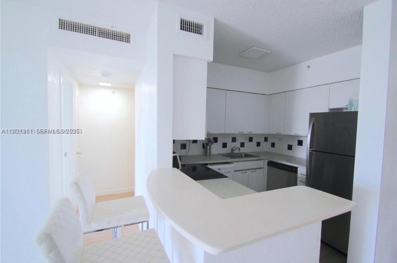 1500 Bay Road, Unit 374S Miami Beach, FL 33139 - Photo 11 of 33 a kitchen with a refrigerator and a sink