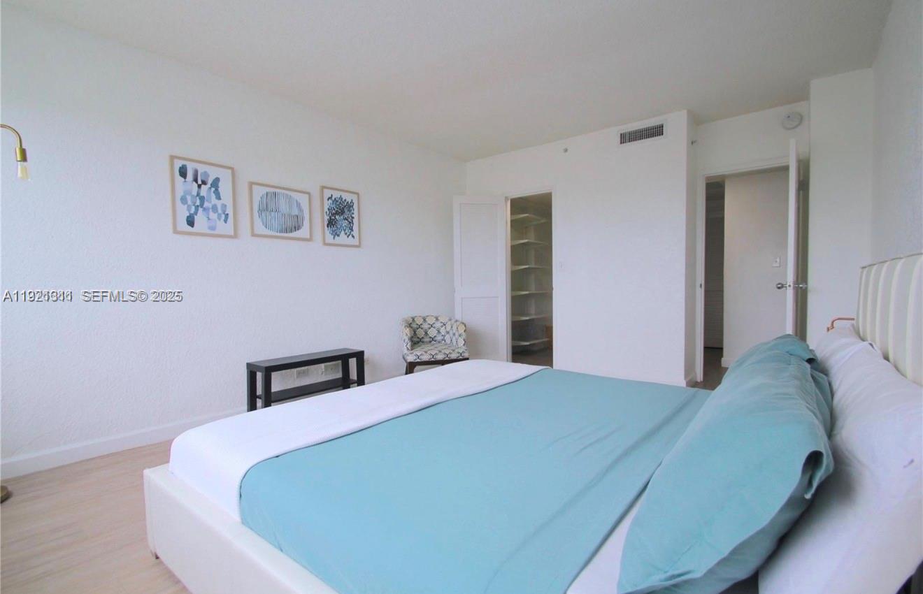 1500 Bay Road, Unit 374S Miami Beach, FL 33139 - Photo 14 of 33 a bedroom with a bed and a wall painting