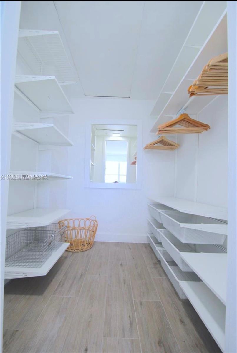 1500 Bay Road, Unit 374S Miami Beach, FL 33139 - Photo 17 of 33 a view of empty room with wooden floor and fan