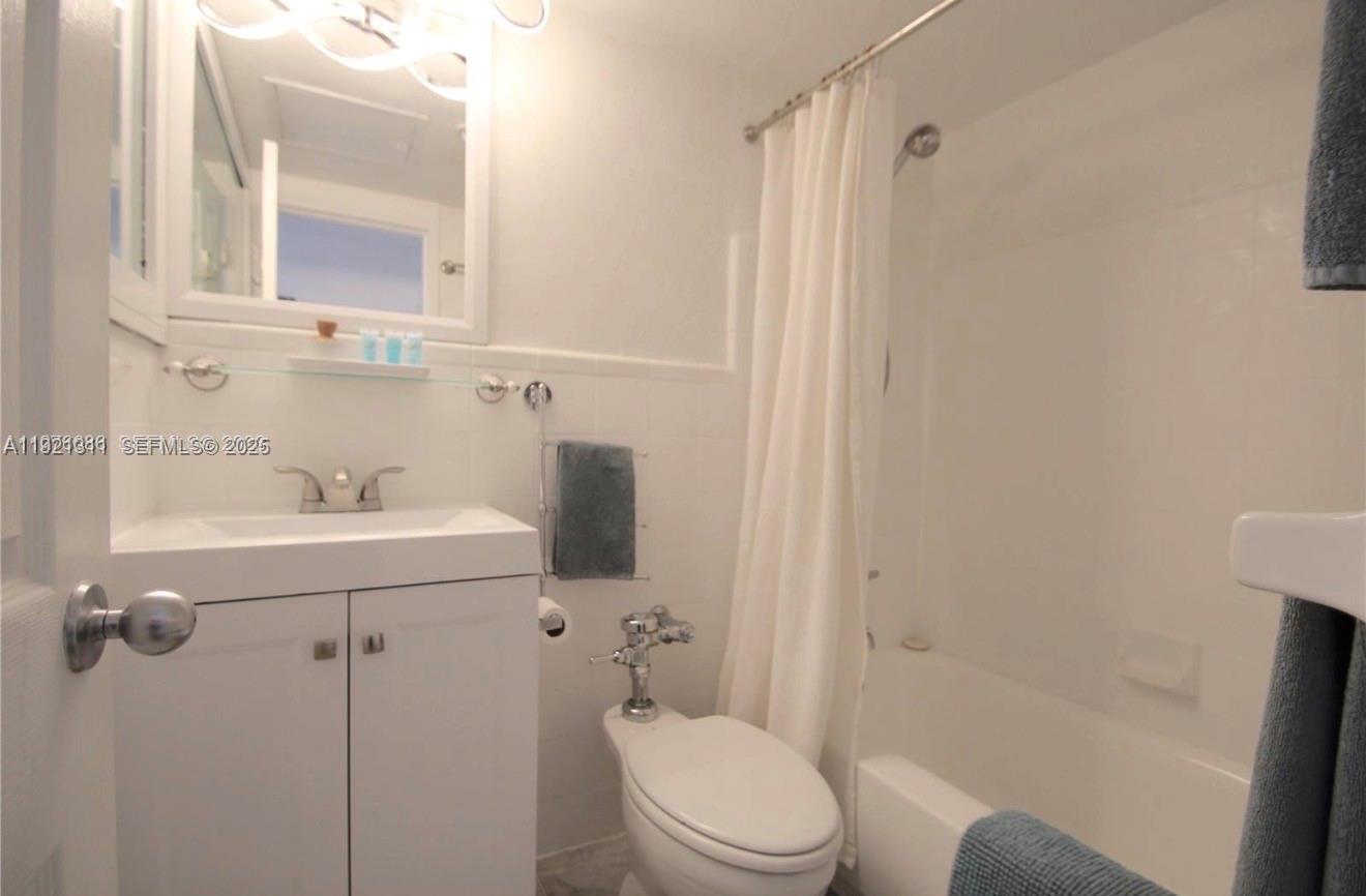 1500 Bay Road, Unit 374S Miami Beach, FL 33139 - Photo 18 of 33 a bathroom with a sink a toilet and shower