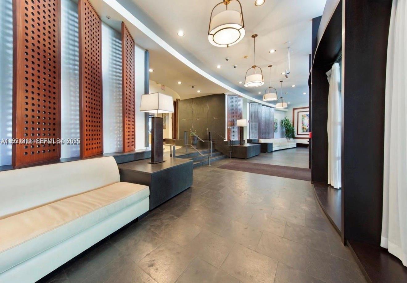 1500 Bay Road, Unit 374S Miami Beach, FL 33139 - Photo 24 of 33 a lobby with furniture and a large window