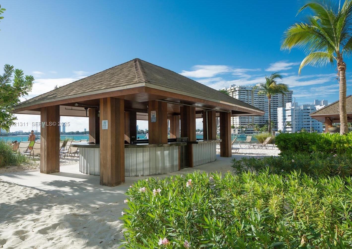 1500 Bay Road, Unit 374S Miami Beach, FL 33139 - Photo 29 of 33 a view of a house with a swimming pool and porch with furniture