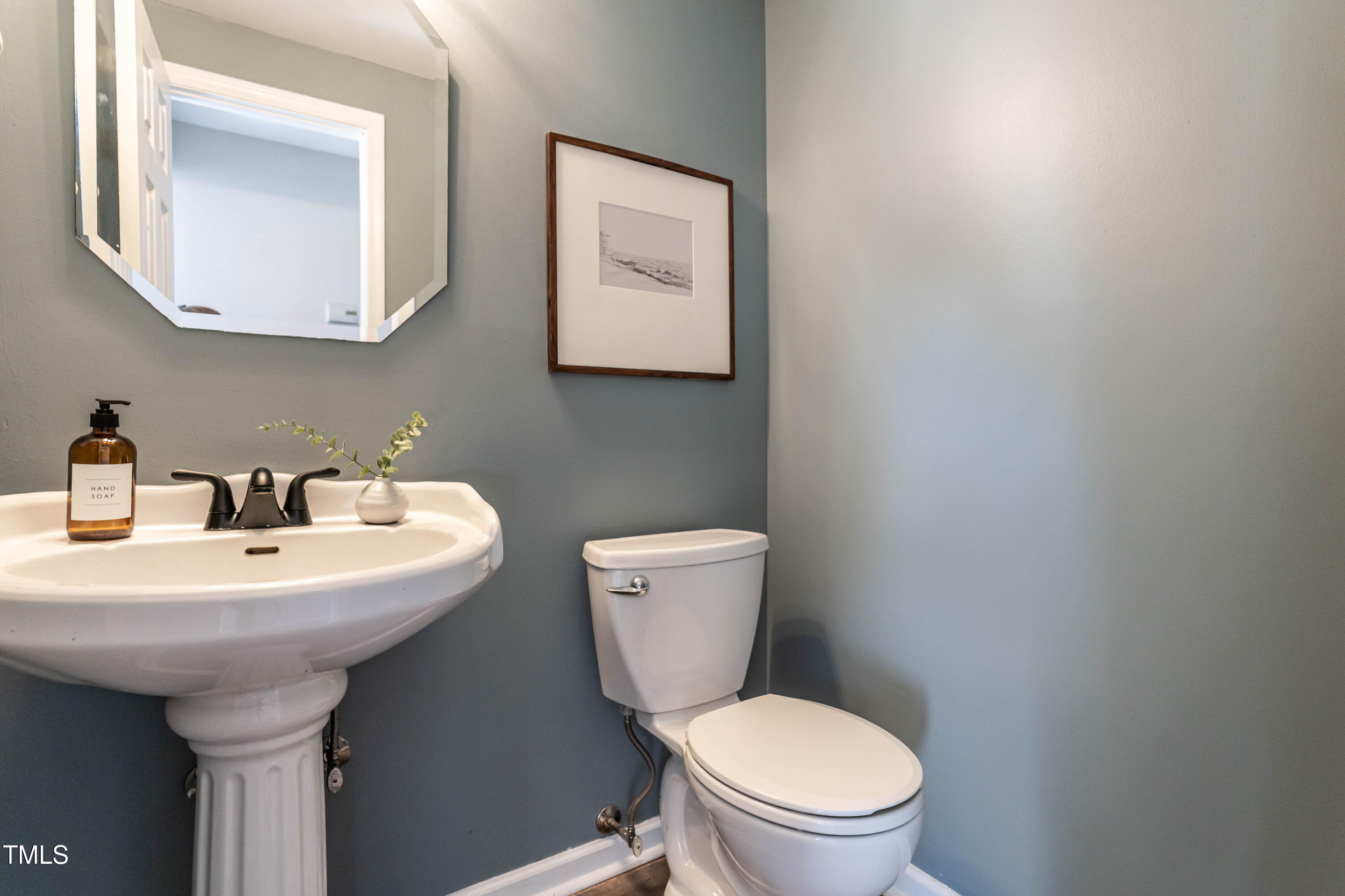 1001 Whetstone Court Raleigh, NC 27615 - Photo 13 of 31 a bathroom with a toilet sink and mirror