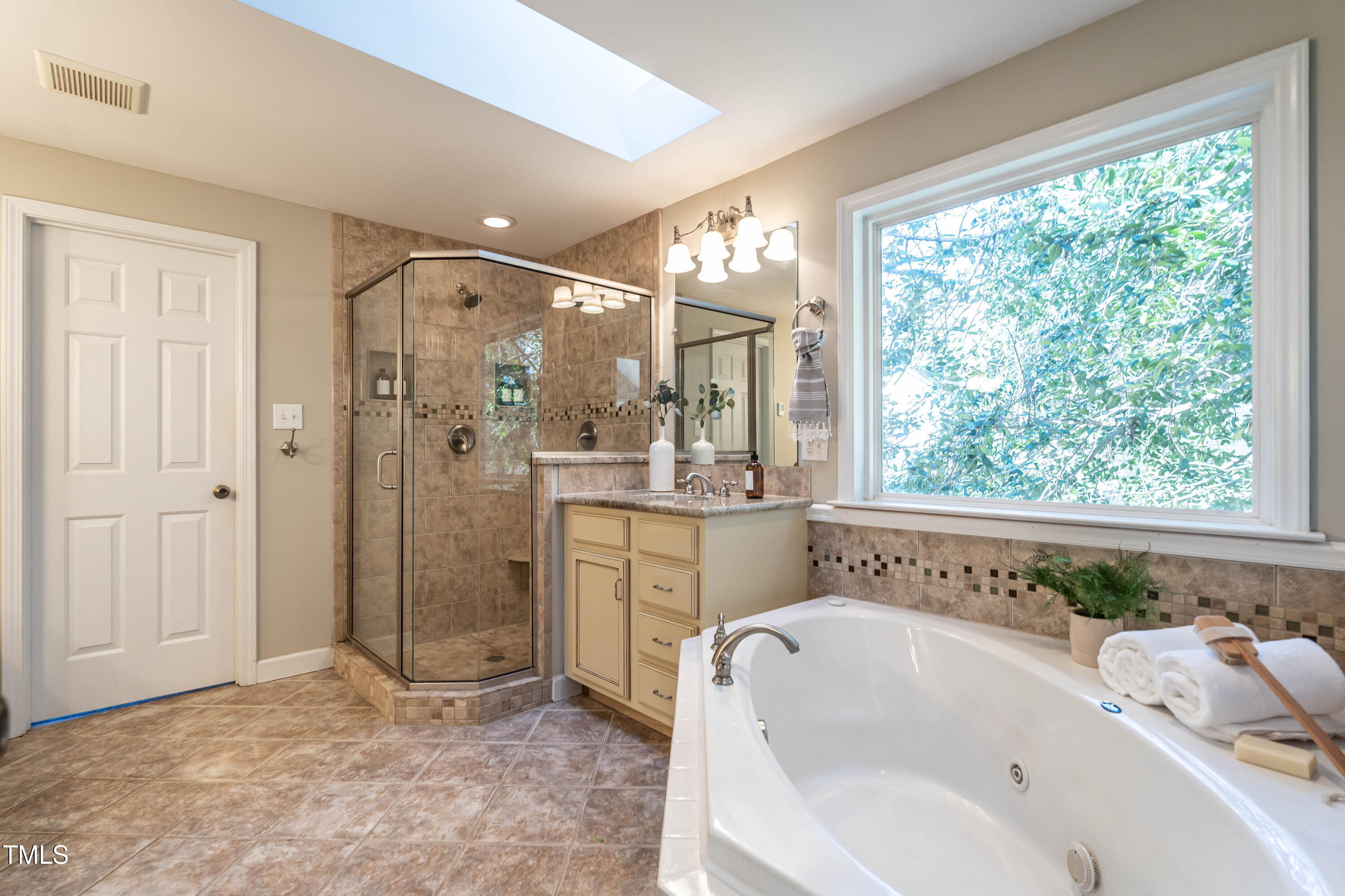 1001 Whetstone Court Raleigh, NC 27615 - Photo 16 of 31 a bathroom with a tub a sink and shower
