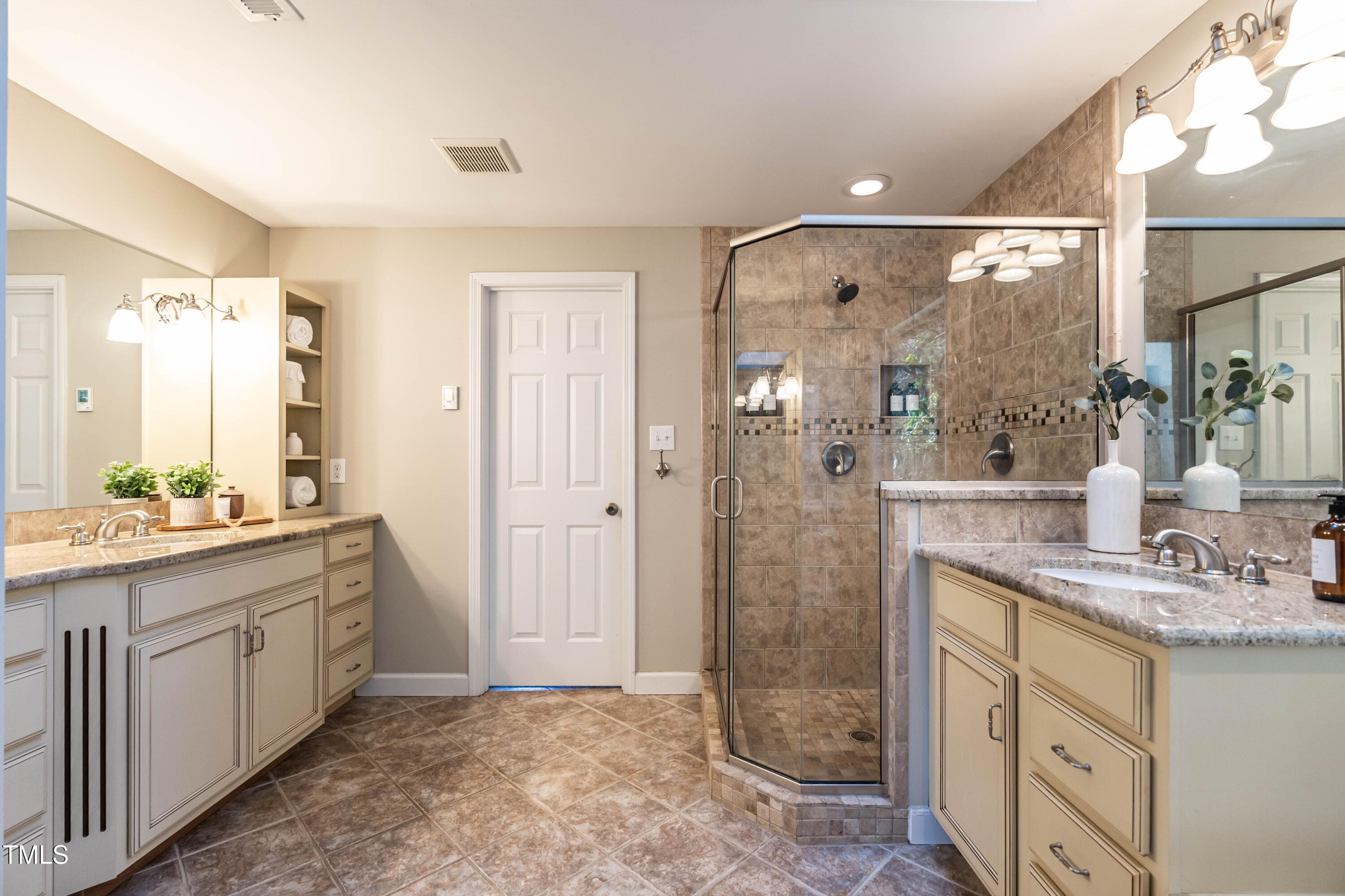 1001 Whetstone Court Raleigh, NC 27615 - Photo 17 of 31 a bathroom with a granite countertop sink mirror and a shower