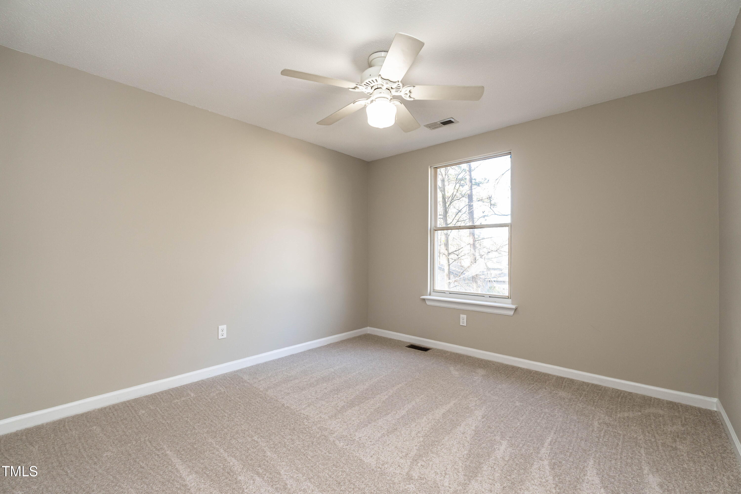1001 Whetstone Court Raleigh, NC 27615 - Photo 23 of 31 an empty room with chandelier fan and windows