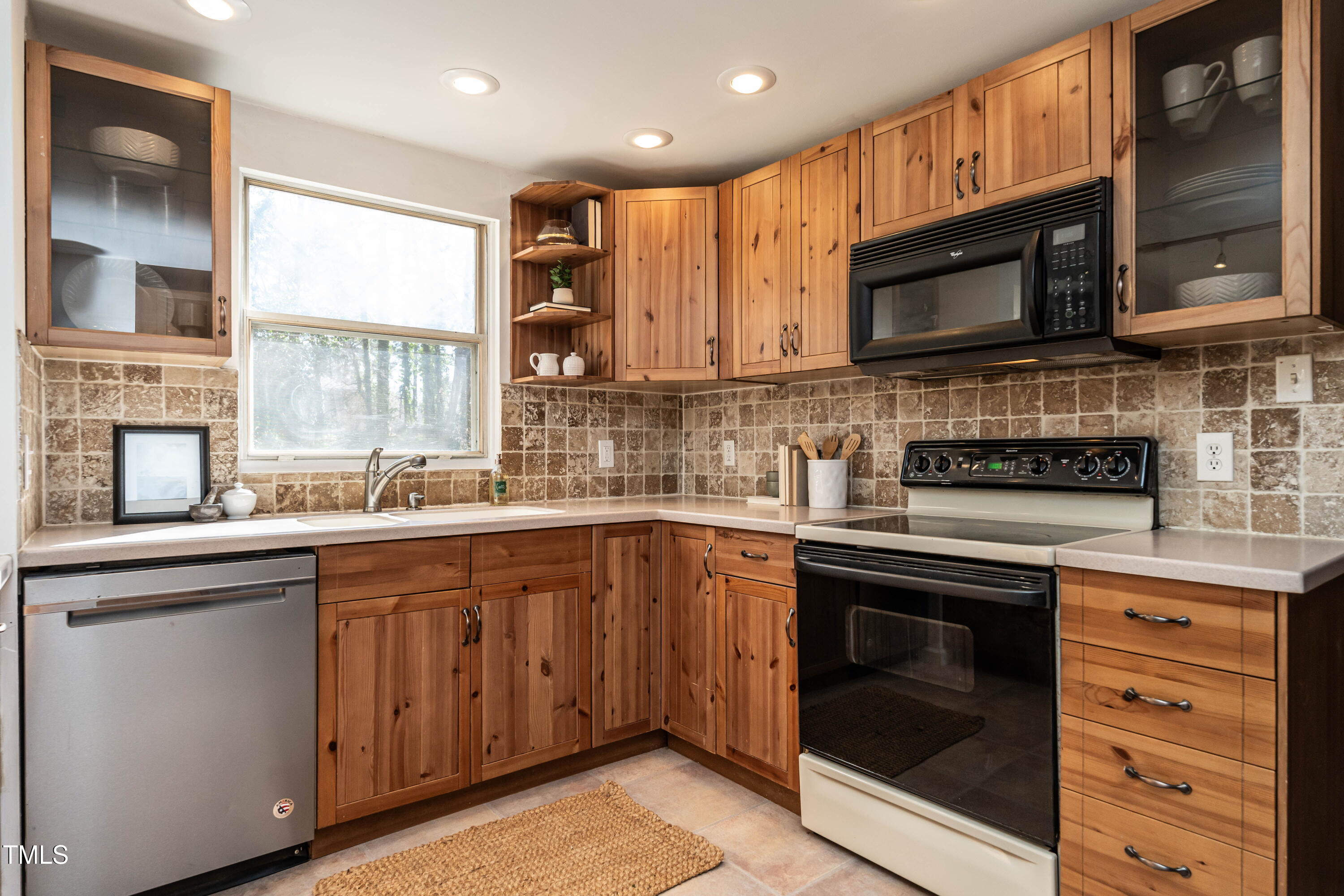 1001 Whetstone Court Raleigh, NC 27615 - Photo 6 of 31 a kitchen with stainless steel appliances granite countertop a stove top oven a sink and a microwave
