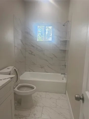 a bathroom with a toilet and a bathtub