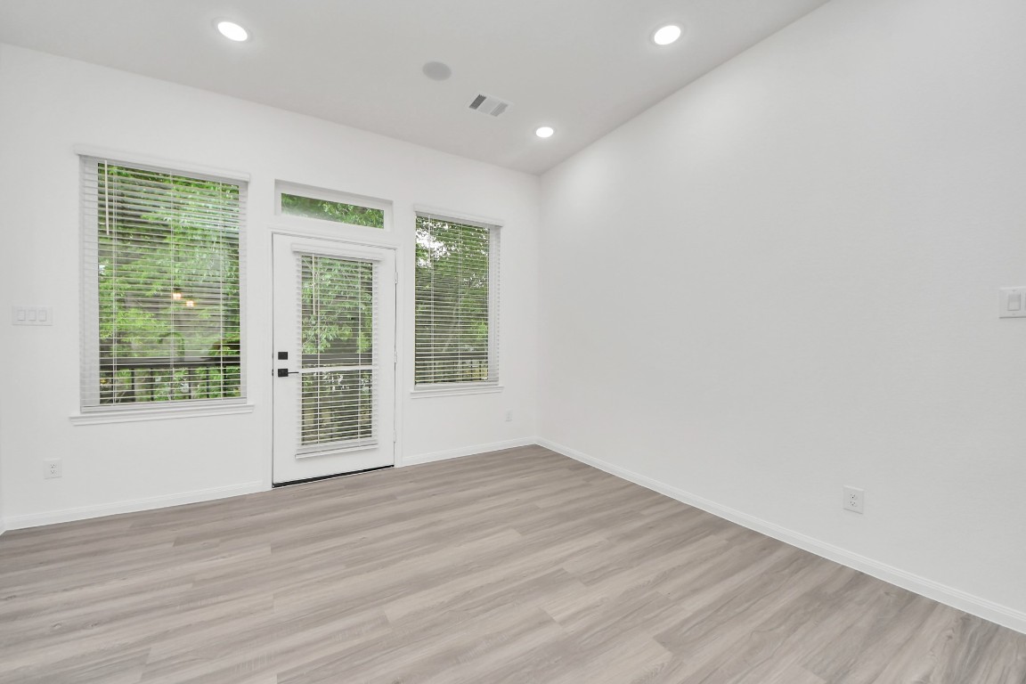 5103 Mallow Street, Unit B Houston, TX 77033 - Photo 12 of 30 a view of an empty room with wooden floor and a window