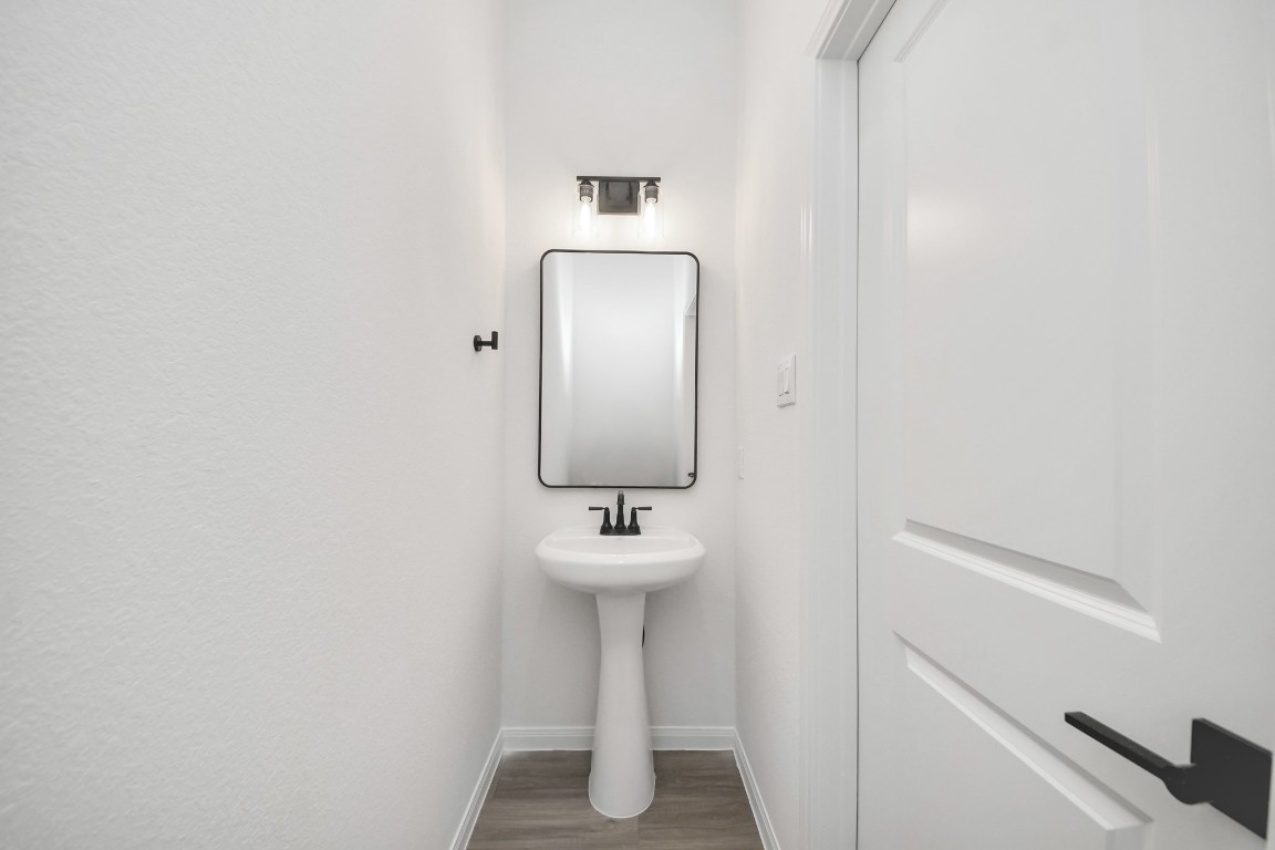 5103 Mallow Street, Unit B Houston, TX 77033 - Photo 13 of 30 a bathroom with a sink and a mirror