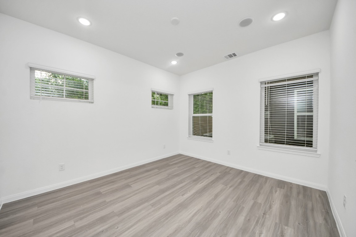 5103 Mallow Street, Unit B Houston, TX 77033 - Photo 15 of 30 a view of empty room with wooden floor and fan