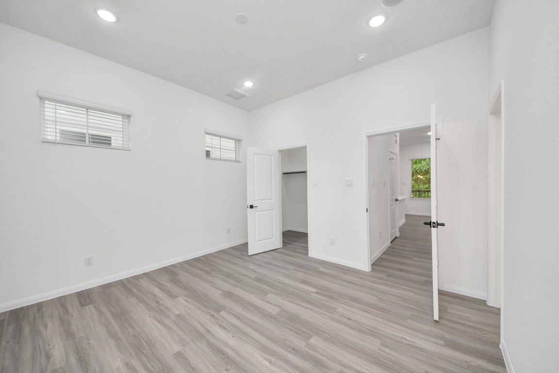5103 Mallow Street, Unit B Houston, TX 77033 - Photo 17 of 30 an empty room with wooden floor and windows