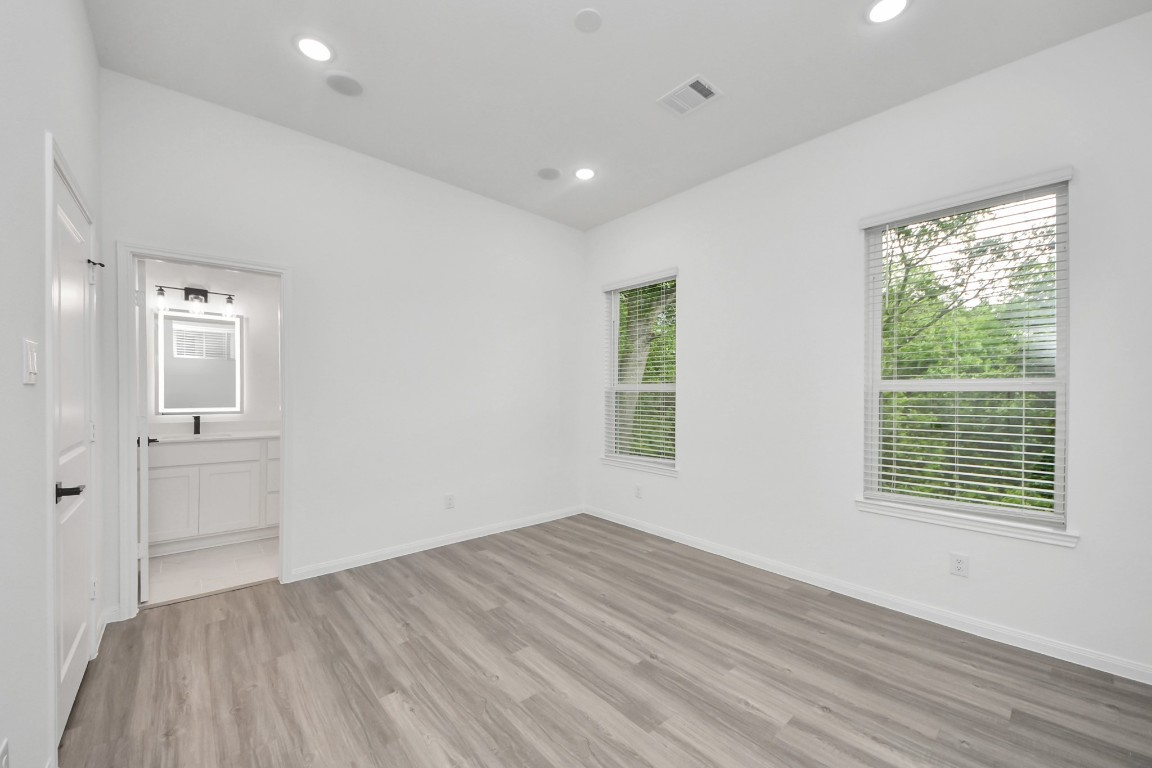 5103 Mallow Street, Unit B Houston, TX 77033 - Photo 18 of 30 a view of empty room with wooden floor and fan