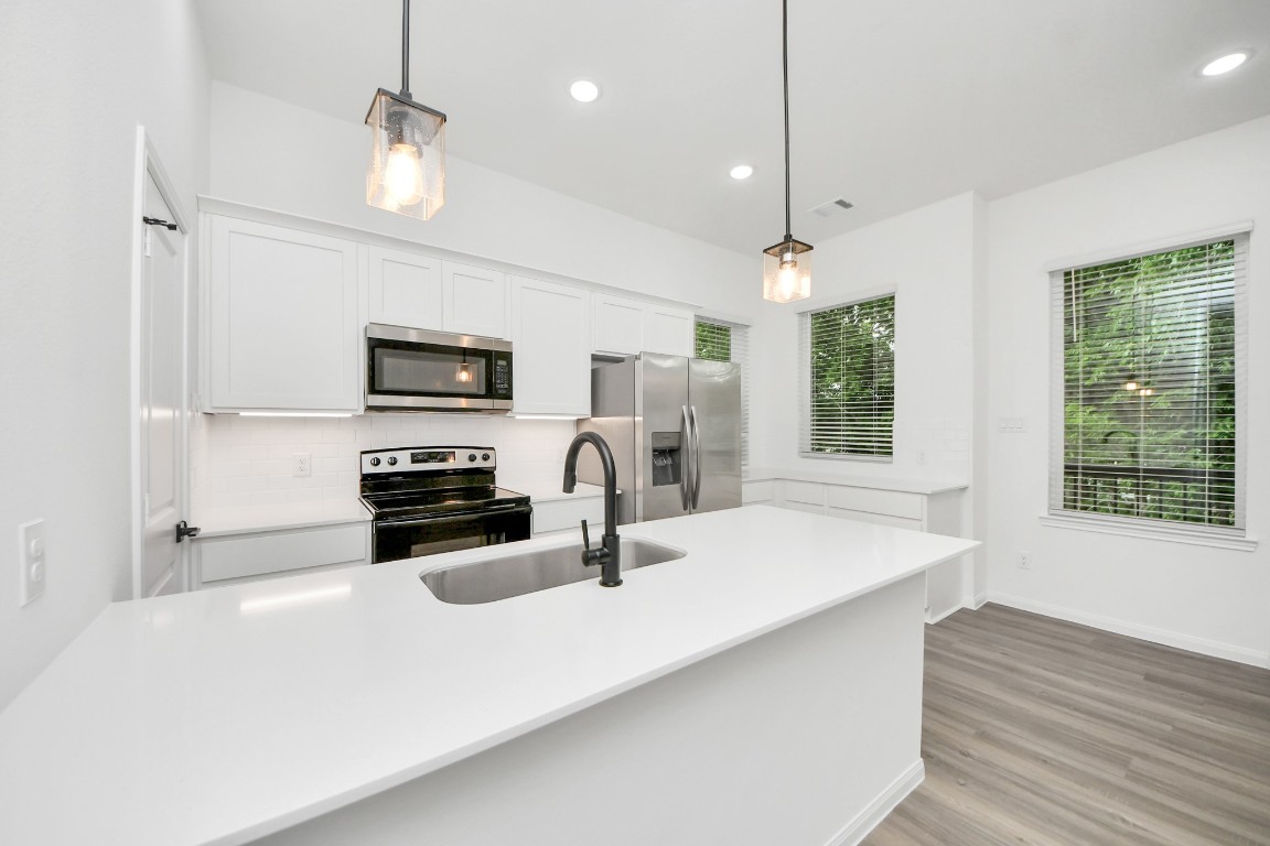 5103 Mallow Street, Unit B Houston, TX 77033 - Photo 2 of 30 a kitchen with stainless steel appliances a microwave sink refrigerator and microwave