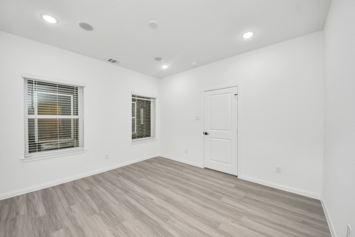 5103 Mallow Street, Unit B Houston, TX 77033 - Photo 22 of 30 a view of empty room with wooden floor and fan