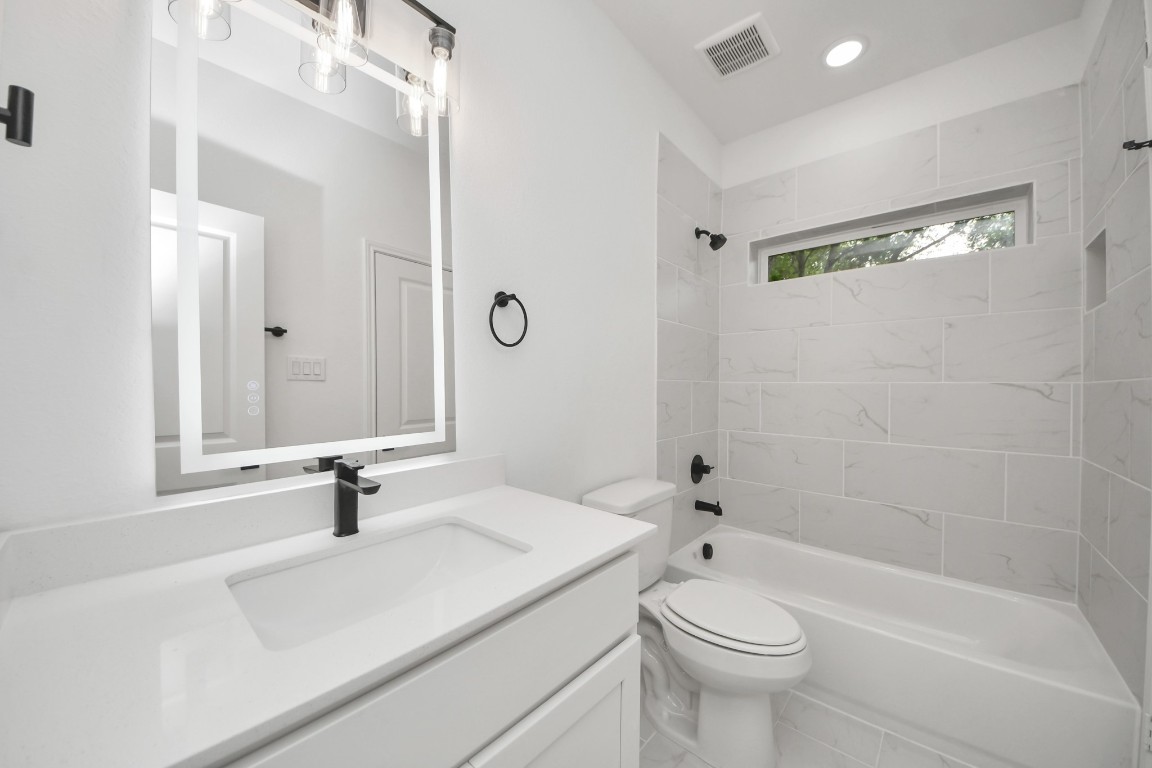 5103 Mallow Street, Unit B Houston, TX 77033 - Photo 23 of 30 a bathroom with a sink a toilet and shower