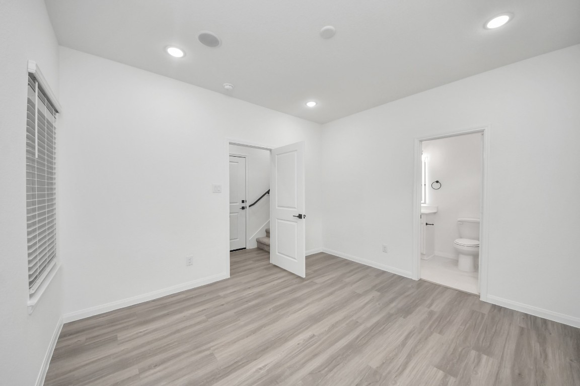 5103 Mallow Street, Unit B Houston, TX 77033 - Photo 24 of 30 wooden floor in an empty room with a window