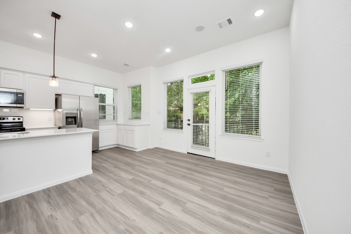 5103 Mallow Street, Unit B Houston, TX 77033 - Photo 4 of 30 a view of a kitchen with wooden floor and windows