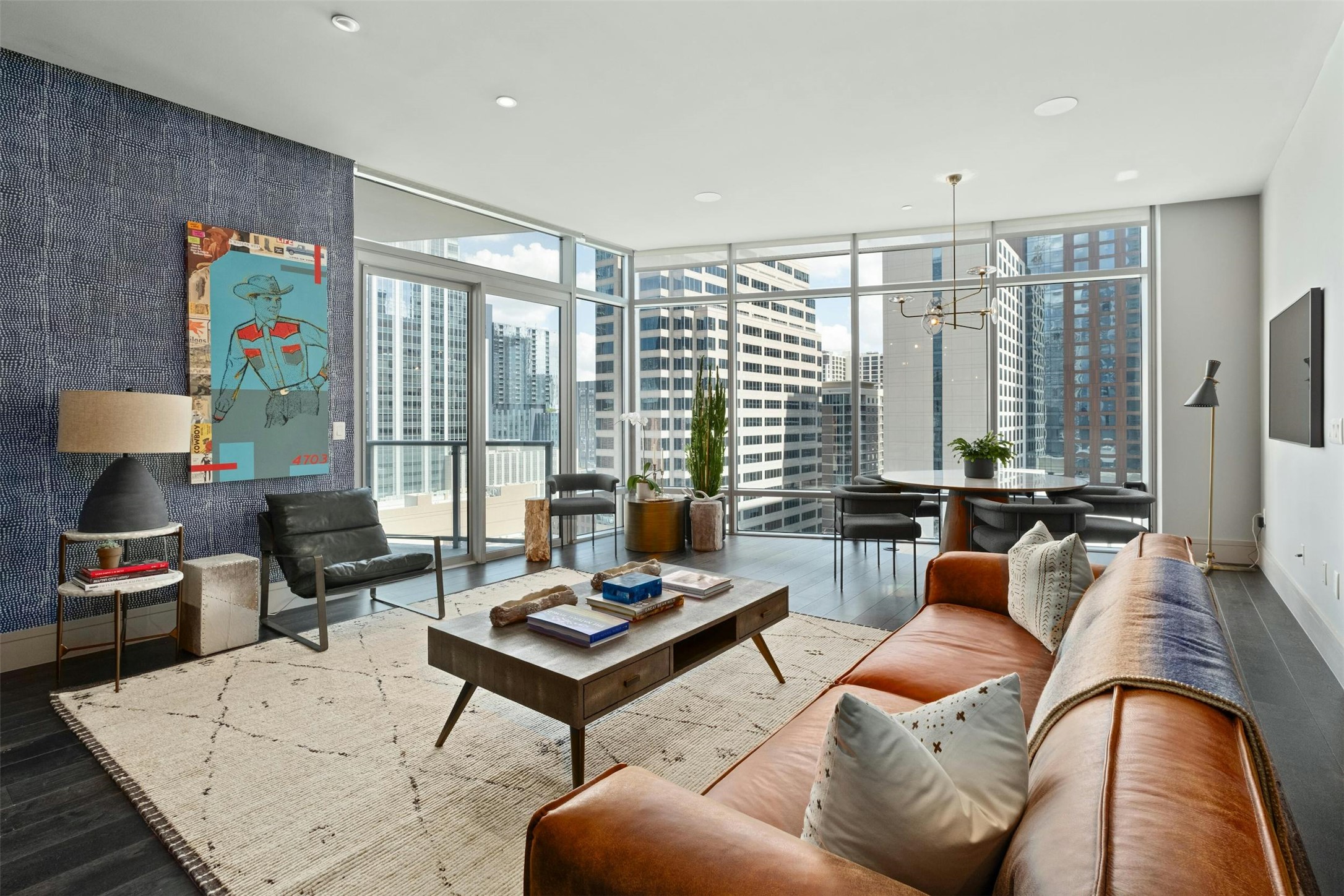 a living room with furniture and a floor to ceiling window