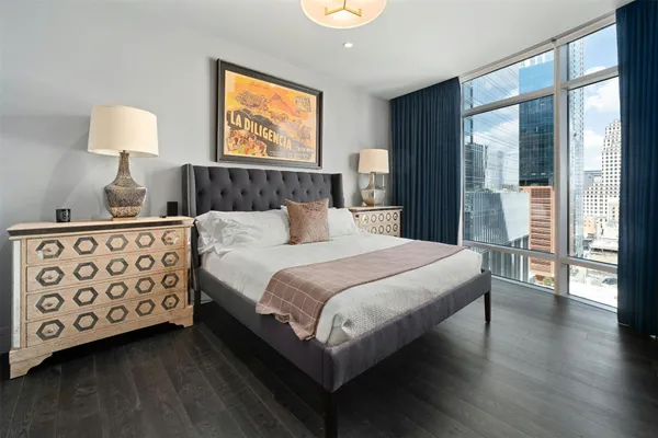 a bedroom with a large bed and a lamp on table