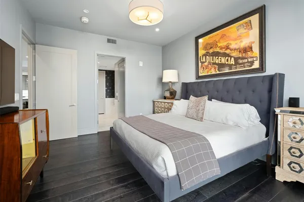 a bedroom with a bed and a flat screen tv