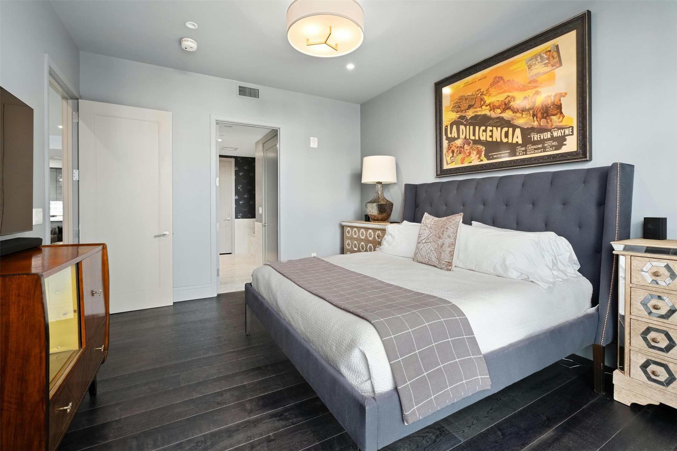 200 Congress Avenue, Unit 15D Austin, TX 78701 - Photo 12 of 23 a bedroom with a bed and a flat screen tv