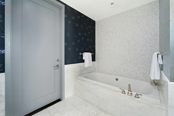 a bathroom with a bathtub and shower