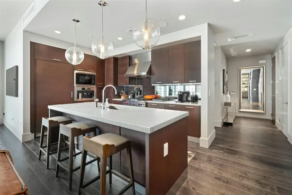 a kitchen with a table chairs and a chandelier