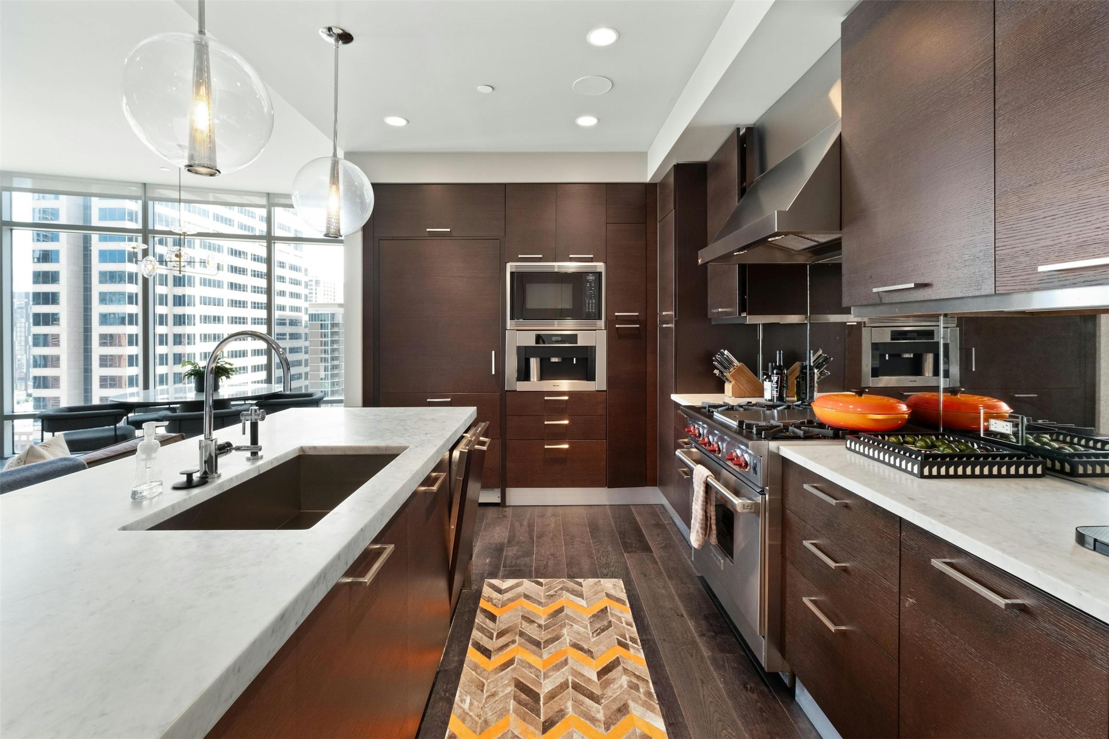 200 Congress Avenue, Unit 15D Austin, TX 78701 - Photo 5 of 23 a kitchen with stainless steel appliances a sink a stove and a wooden floors