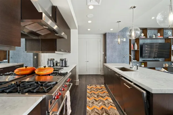 a kitchen with stainless steel appliances granite countertop a stove and a sink