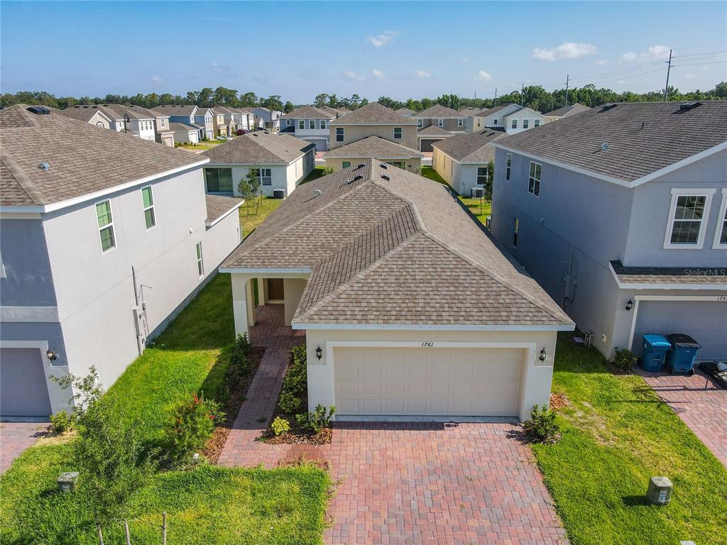 1761 Tree Shade Drive Davenport, FL 33837 - Photo 1 of 20 a front view of a house with a yard and lake view