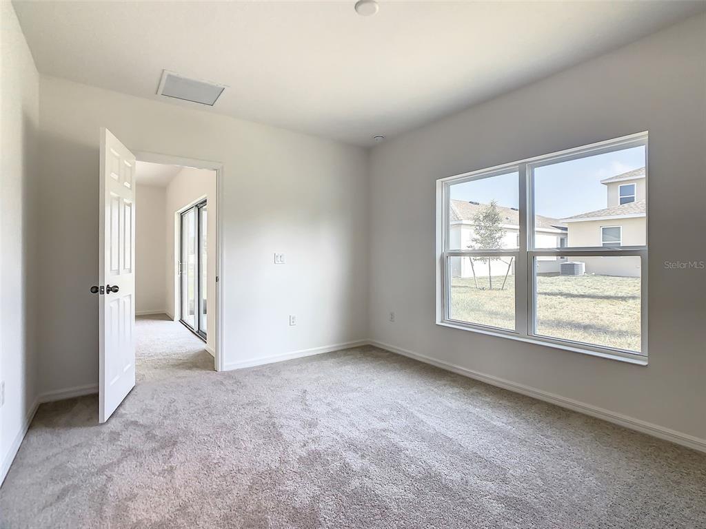 1761 Tree Shade Drive Davenport, FL 33837 - Photo 12 of 20 an empty room with windows and closet