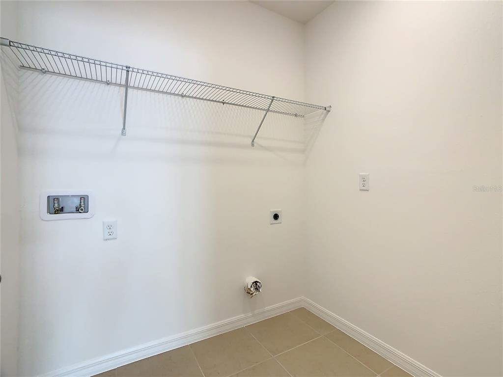 1761 Tree Shade Drive Davenport, FL 33837 - Photo 19 of 20 a bathroom with a shower and cabinets