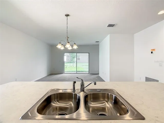 a view of a sink and dishwasher with kitchen island