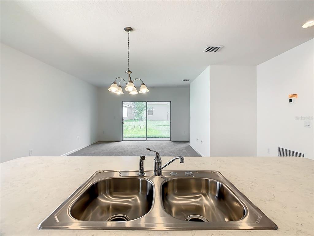 1761 Tree Shade Drive Davenport, FL 33837 - Photo 7 of 20 a view of a sink and dishwasher with kitchen island