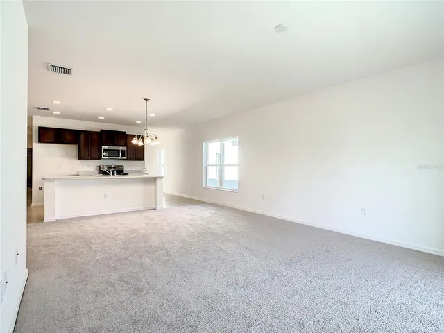 a view of a kitchen with microwave and cabinets